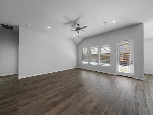 a view of room with wooden floor and ceiling fan