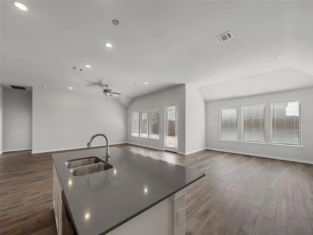 a view of a room with wooden floor and cabinet