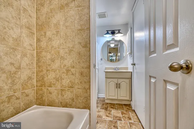 a bathroom with a tub and a shower