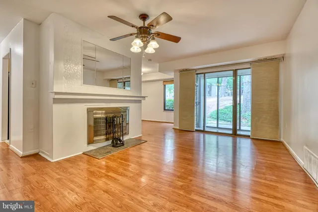 a view of an empty room with window and fire place