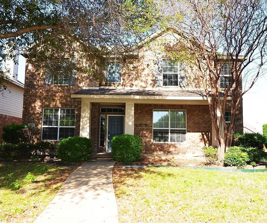 a front view of a house with a yard garage and outdoor seating