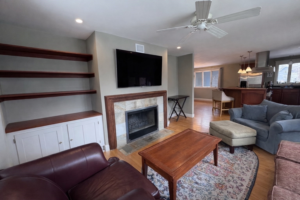 127 Preservation Way Tiverton, RI 02878 - Photo 12 of 41 a living room with furniture a flat screen tv and a fireplace
