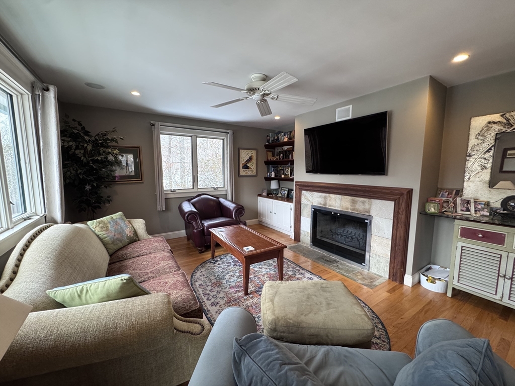 127 Preservation Way Tiverton, RI 02878 - Photo 13 of 41 a living room with furniture a fireplace and a flat screen tv