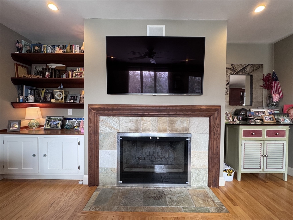 127 Preservation Way Tiverton, RI 02878 - Photo 15 of 41 a living room with hard wood floors and a fireplace