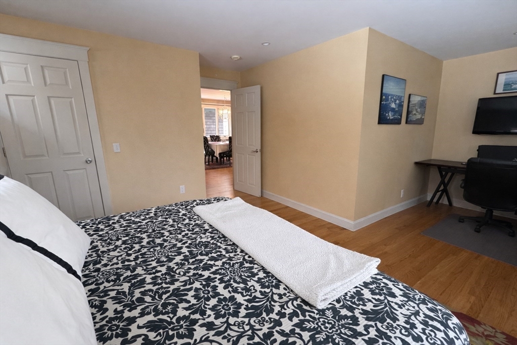 127 Preservation Way Tiverton, RI 02878 - Photo 20 of 41 a bedroom with a bed and wooden floor