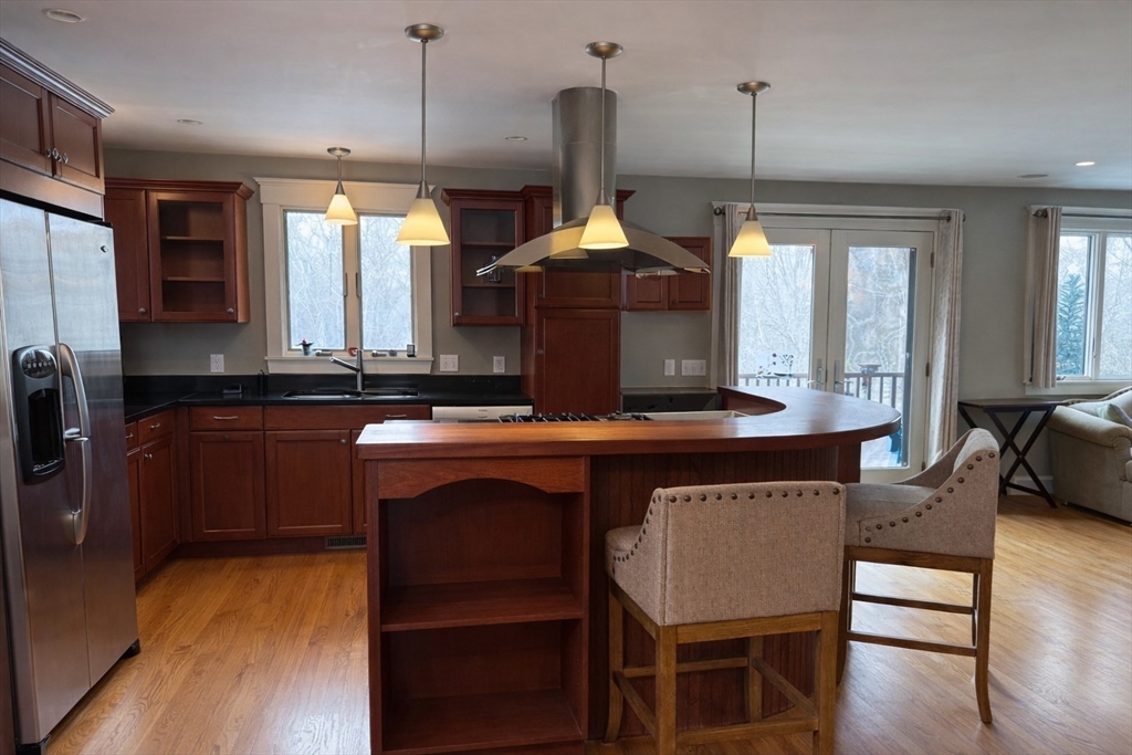 127 Preservation Way Tiverton, RI 02878 - Photo 2 of 41 a kitchen with a table chairs and wooden floor