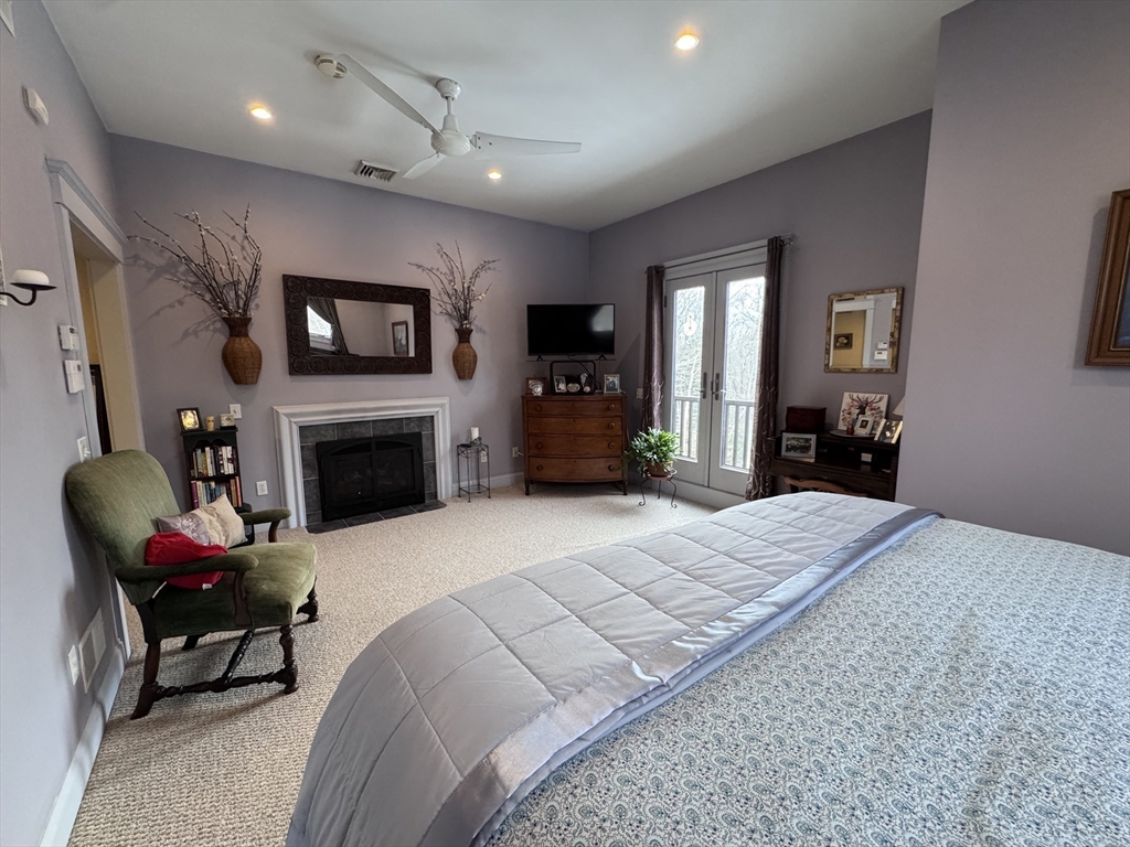 127 Preservation Way Tiverton, RI 02878 - Photo 28 of 41 a living room with furniture a flat screen tv and a fireplace