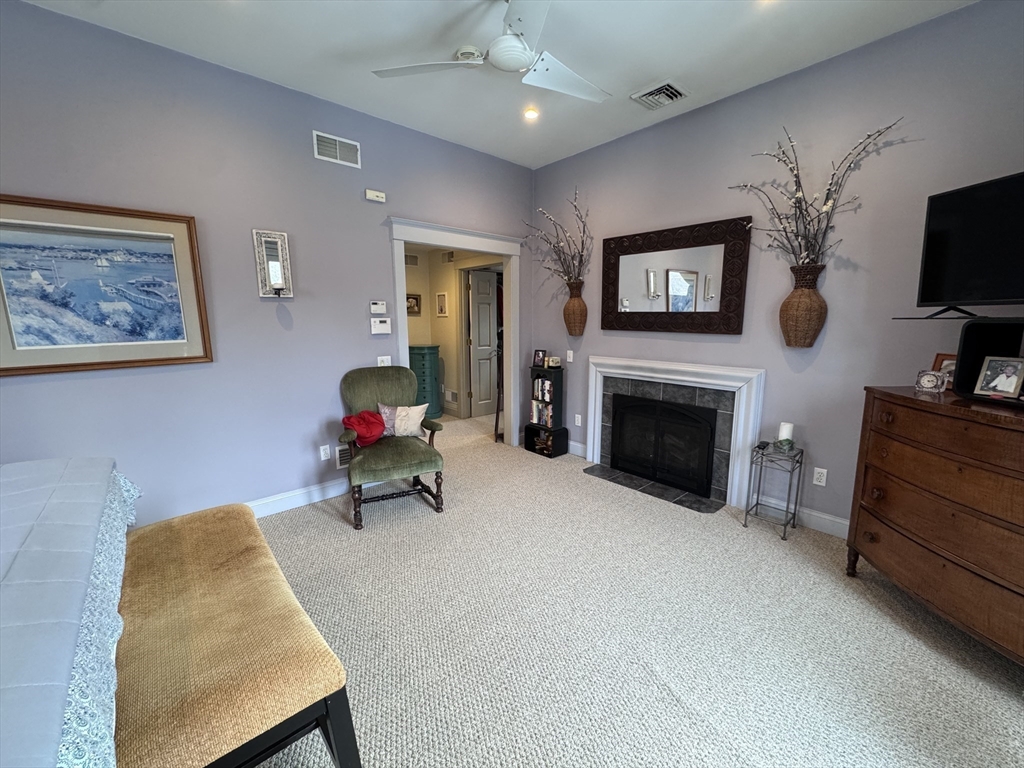 127 Preservation Way Tiverton, RI 02878 - Photo 29 of 41 a bedroom with furniture and a fireplace