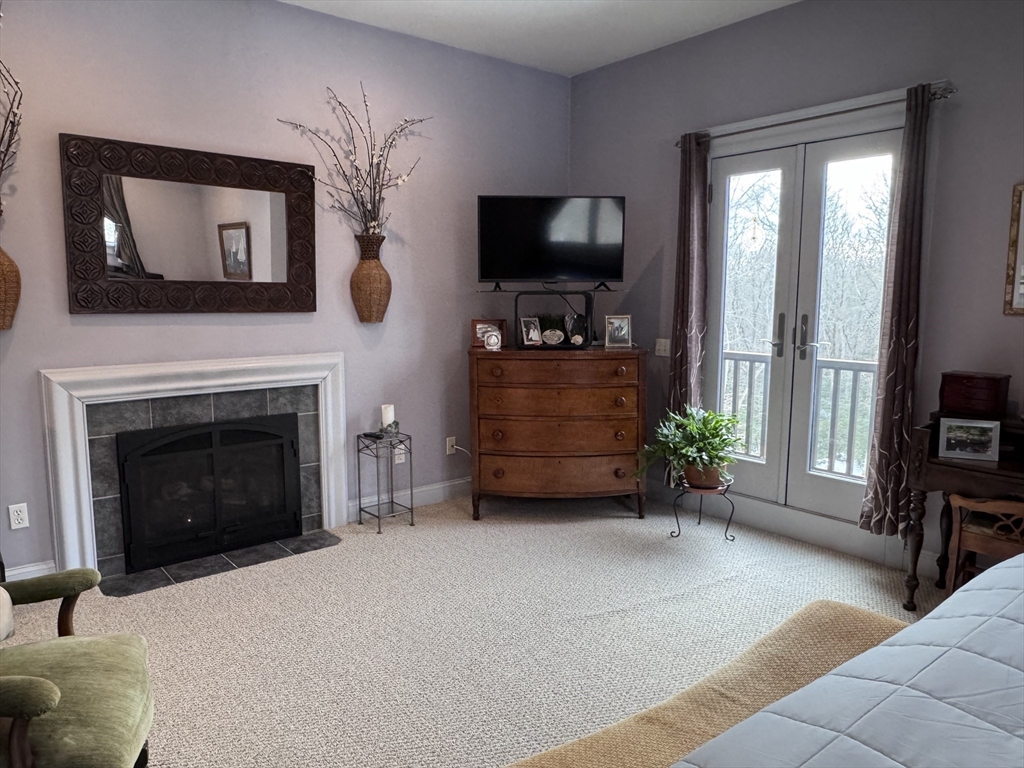 127 Preservation Way Tiverton, RI 02878 - Photo 30 of 41 a living room with furniture a flat screen tv and a fireplace
