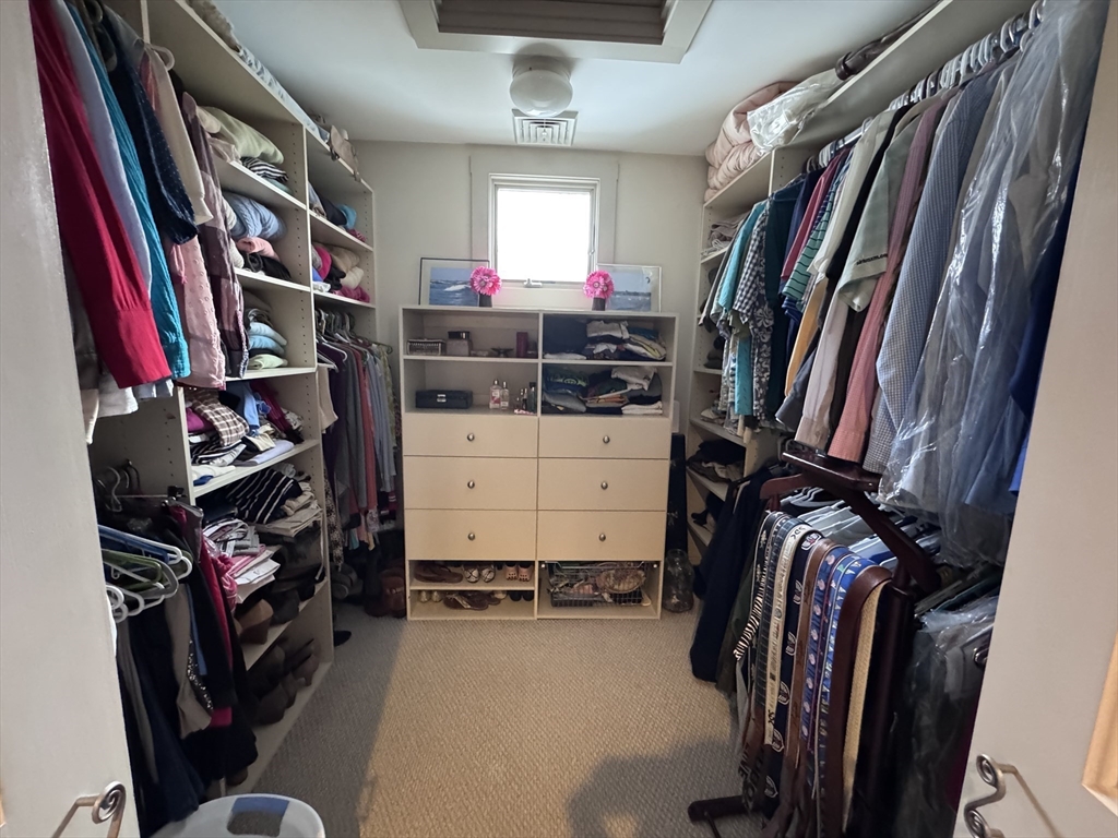 127 Preservation Way Tiverton, RI 02878 - Photo 35 of 41 a view of walk in closet with clothes and shoes