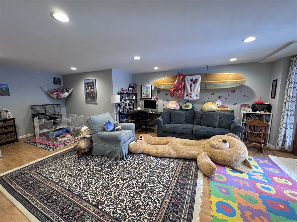127 Preservation Way Tiverton, RI 02878 - Photo 37 of 41 a living room filled with furniture and a rug