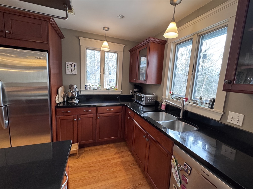 127 Preservation Way Tiverton, RI 02878 - Photo 4 of 41 a large kitchen with kitchen island granite countertop a large window and stainless steel appliances