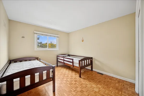 a bedroom with a bed table and chair