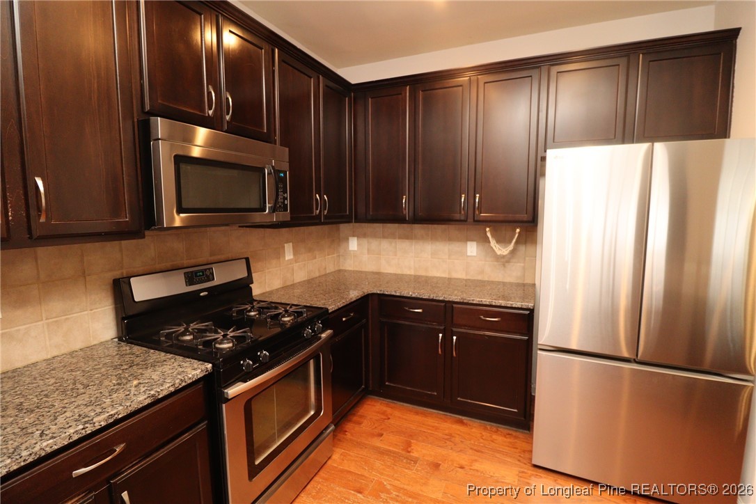 1712 Grace Point Road Morrisville, NC 27560 - Photo 14 of 35 a kitchen with a refrigerator stove and microwave