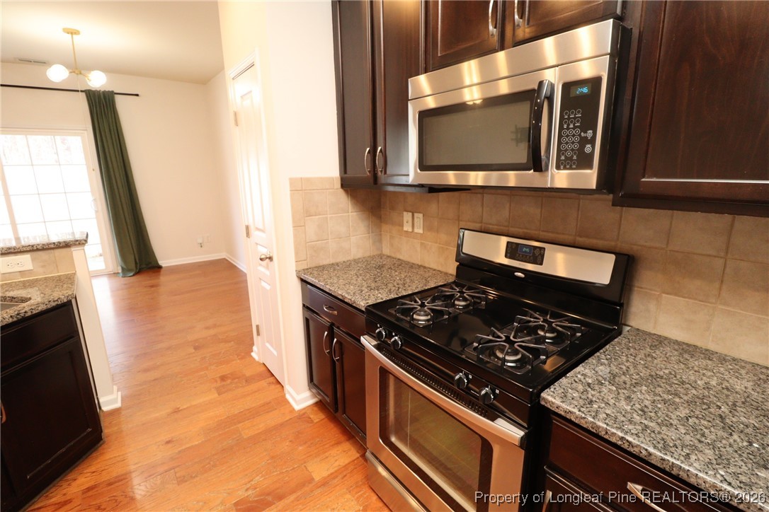 1712 Grace Point Road Morrisville, NC 27560 - Photo 15 of 35 a kitchen with a stove and a microwave