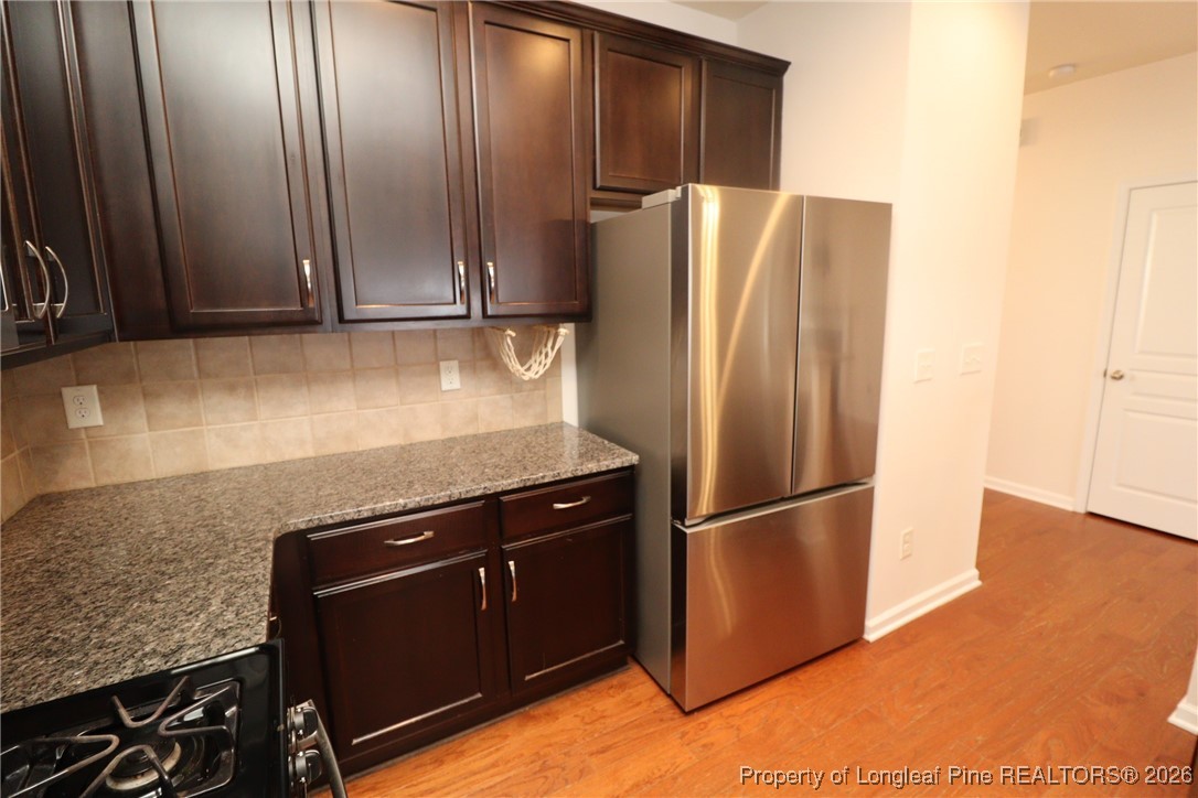 1712 Grace Point Road Morrisville, NC 27560 - Photo 16 of 35 a metallic refrigerator freezer sitting in a kitchen