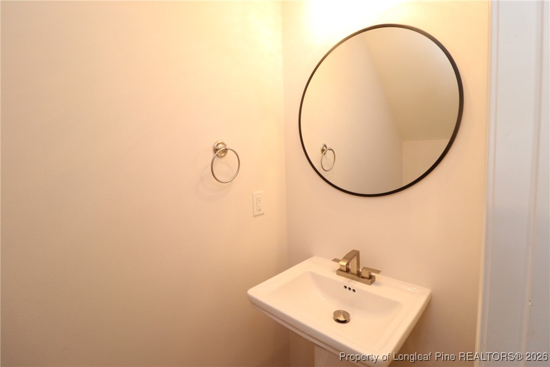 1712 Grace Point Road Morrisville, NC 27560 - Photo 22 of 35 a bathroom with a sink and a mirror