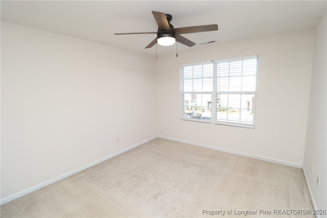 1712 Grace Point Road Morrisville, NC 27560 - Photo 24 of 35 an empty room with a window and a fan