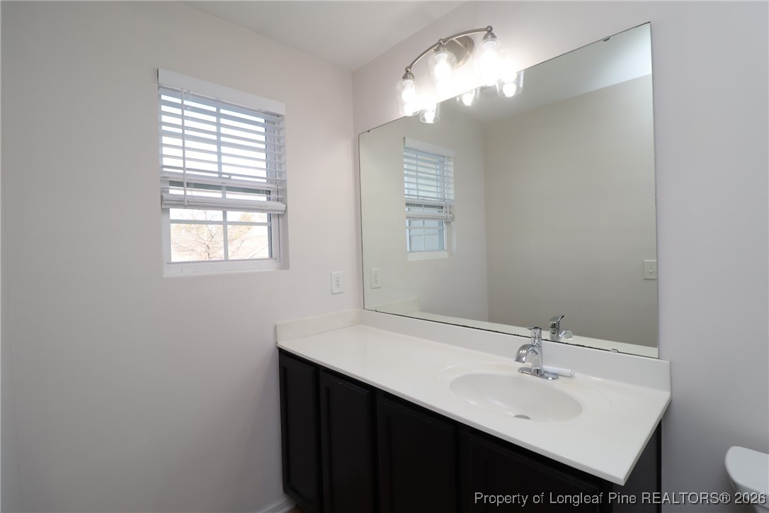 1712 Grace Point Road Morrisville, NC 27560 - Photo 28 of 35 a bathroom with a sink vanity and a mirror