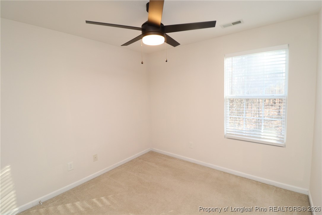 1712 Grace Point Road Morrisville, NC 27560 - Photo 31 of 35 an empty room with a window and a fan