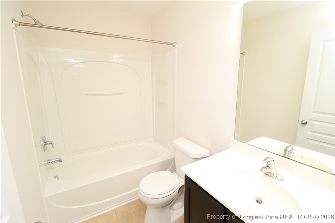 1712 Grace Point Road Morrisville, NC 27560 - Photo 35 of 35 a bathroom with a sink a toilet and shower