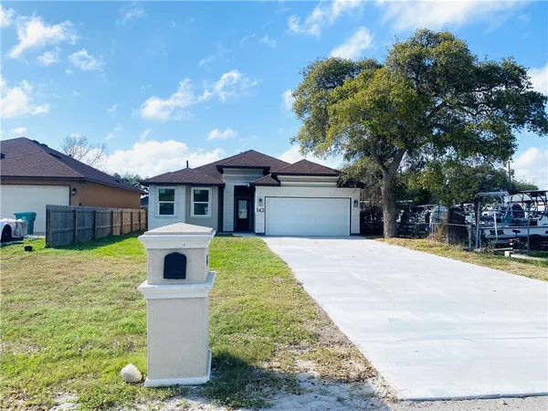 a front view of a house with yard porch and garage