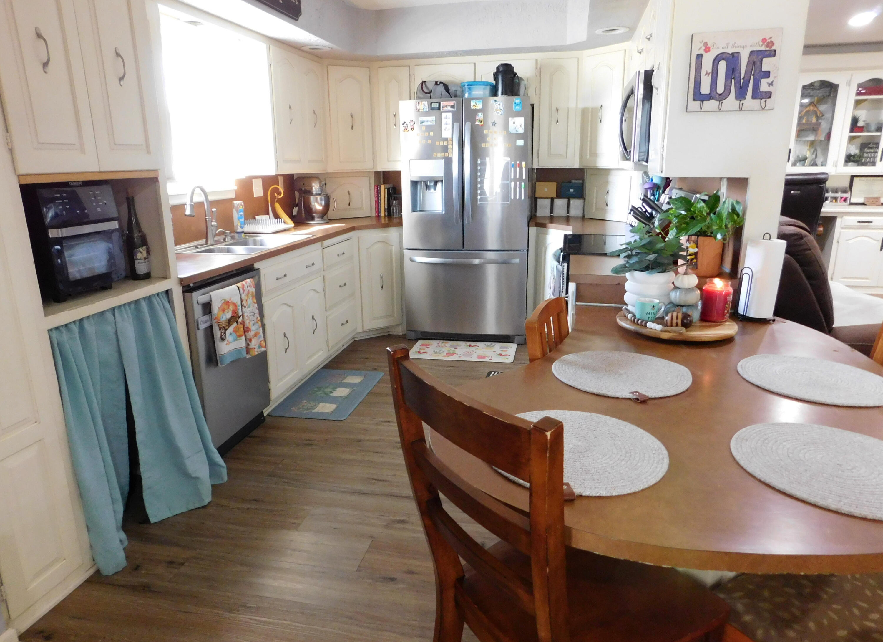1730 West Ave F Muleshoe, TX 79347 - Photo 14 of 32 a kitchen with stainless steel appliances granite countertop a table chairs stove and refrigerator