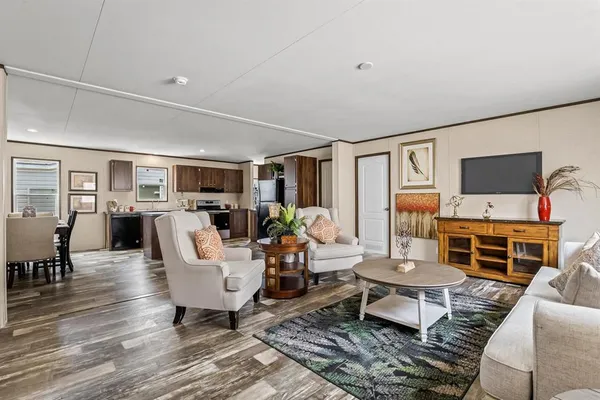 a living room with furniture flat screen tv and a fireplace