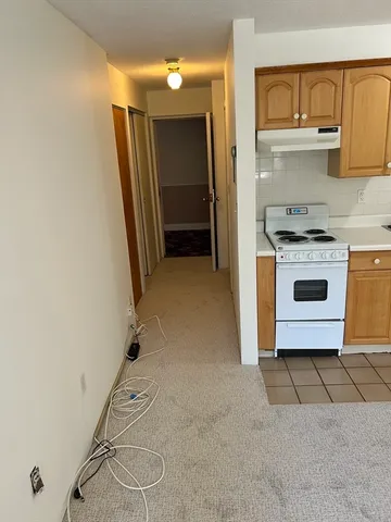 a kitchen with a stove and a refrigerator