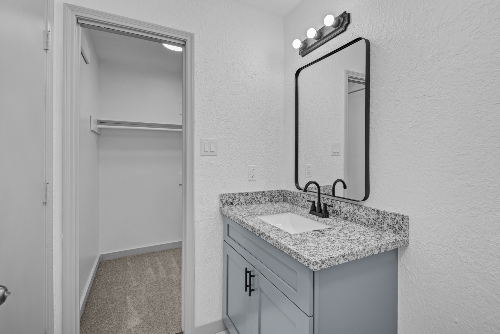 13747 Rampchester Lane Houston, TX 77015 - Photo 17 of 24 a bathroom with a granite countertop sink and a mirror