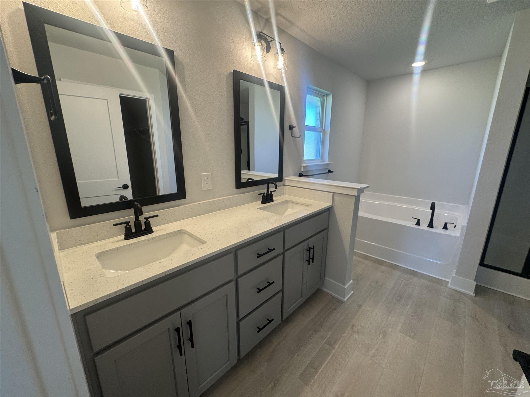 5311 Hidden Pines Circle Milton, FL 32583 - Photo 5 of 7 a bathroom with a double vanity sink and mirror