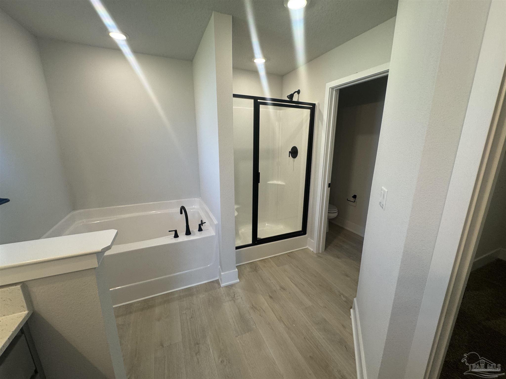 5311 Hidden Pines Circle Milton, FL 32583 - Photo 6 of 7 a bathroom with a bathtub and a shower