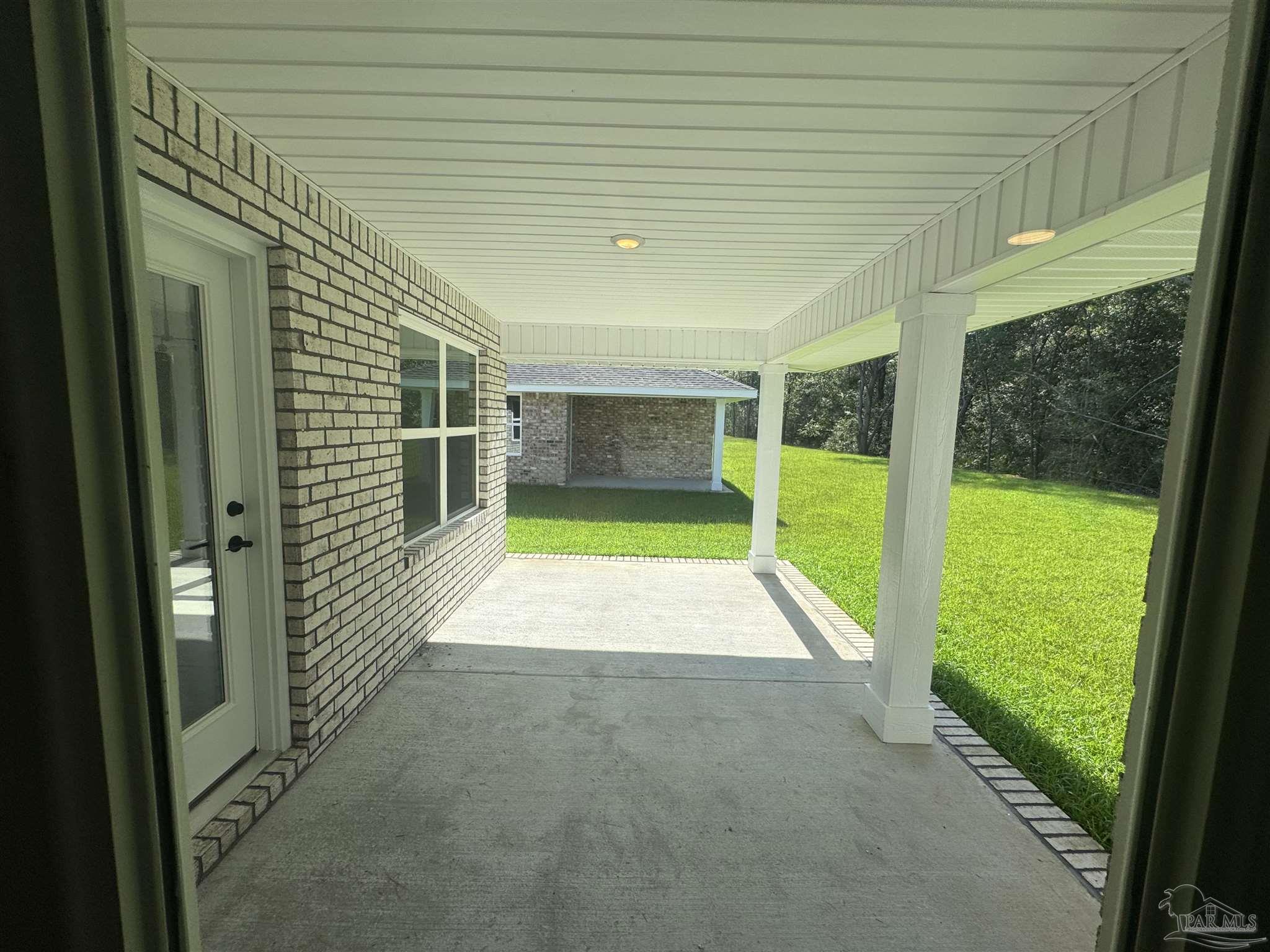 5311 Hidden Pines Circle Milton, FL 32583 - Photo 7 of 7 a view of an empty room with a window and a swimming pool