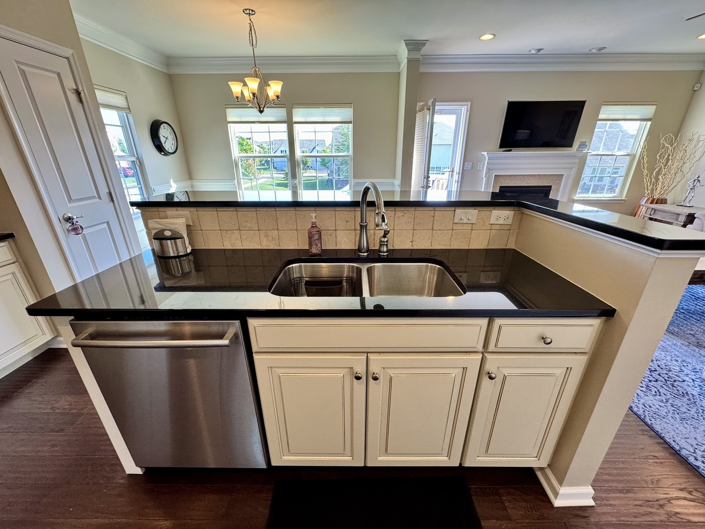 12903 Cypress Lane Plainfield, IL 60585 - Photo 11 of 30 a kitchen with a sink a microwave a dining table and chairs