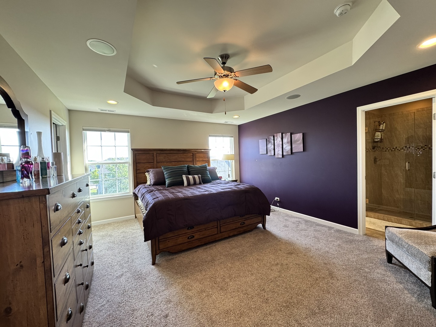 12903 Cypress Lane Plainfield, IL 60585 - Photo 12 of 30 a spacious bedroom with a bed and a chandelier