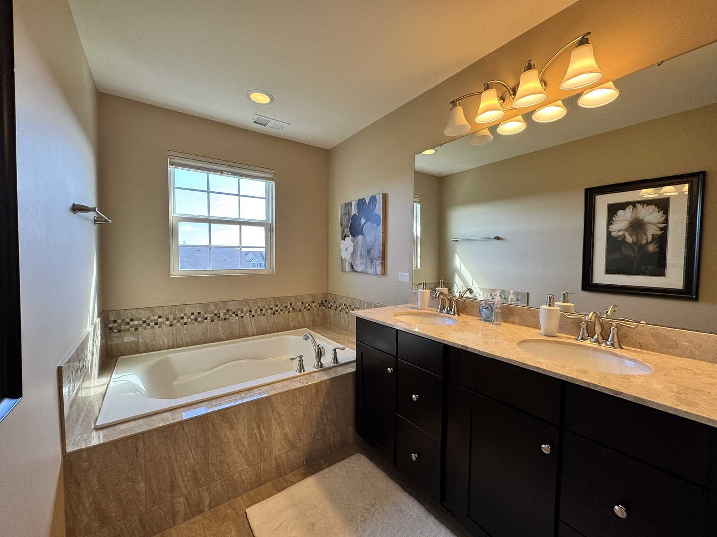 12903 Cypress Lane Plainfield, IL 60585 - Photo 15 of 30 a bathroom with a tub double sink window and mirror