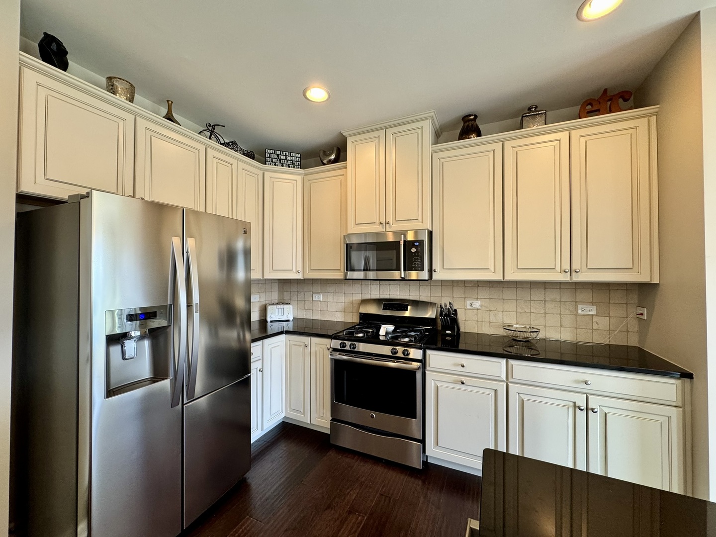 12903 Cypress Lane Plainfield, IL 60585 - Photo 10 of 30 a kitchen with cabinets stainless steel appliances a sink and wooden floor