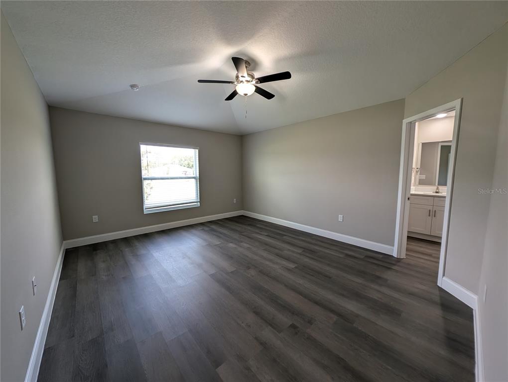 1225 Vanderway Lane Lady Lake, FL 32159 - Photo 7 of 13 a view of empty room with wooden floor and fan