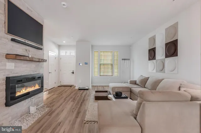 a living room with furniture a flat screen tv and a fireplace