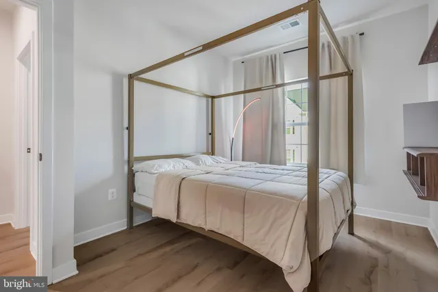 a bedroom with a bed and a mirror