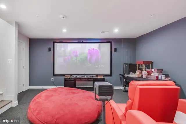 a room with furniture a projector and screen