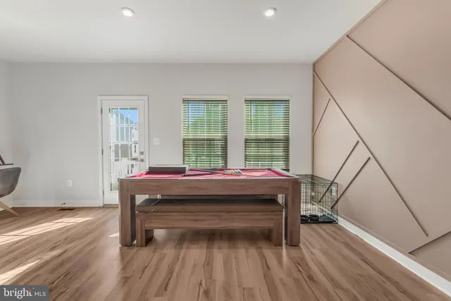 a living room with a balcony and wooden floor