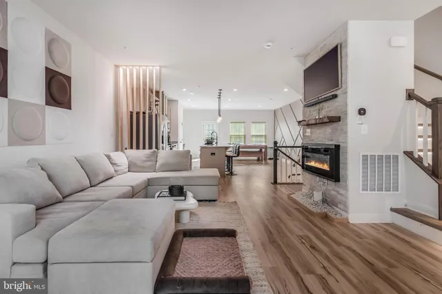 a living room with furniture wooden floor and a flat screen tv