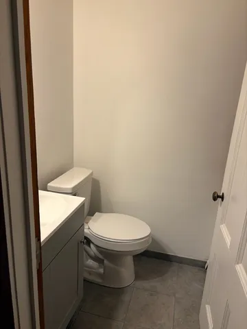 a white toilet sitting next to a white sink