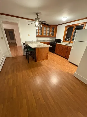 a living room with furniture and a kitchen