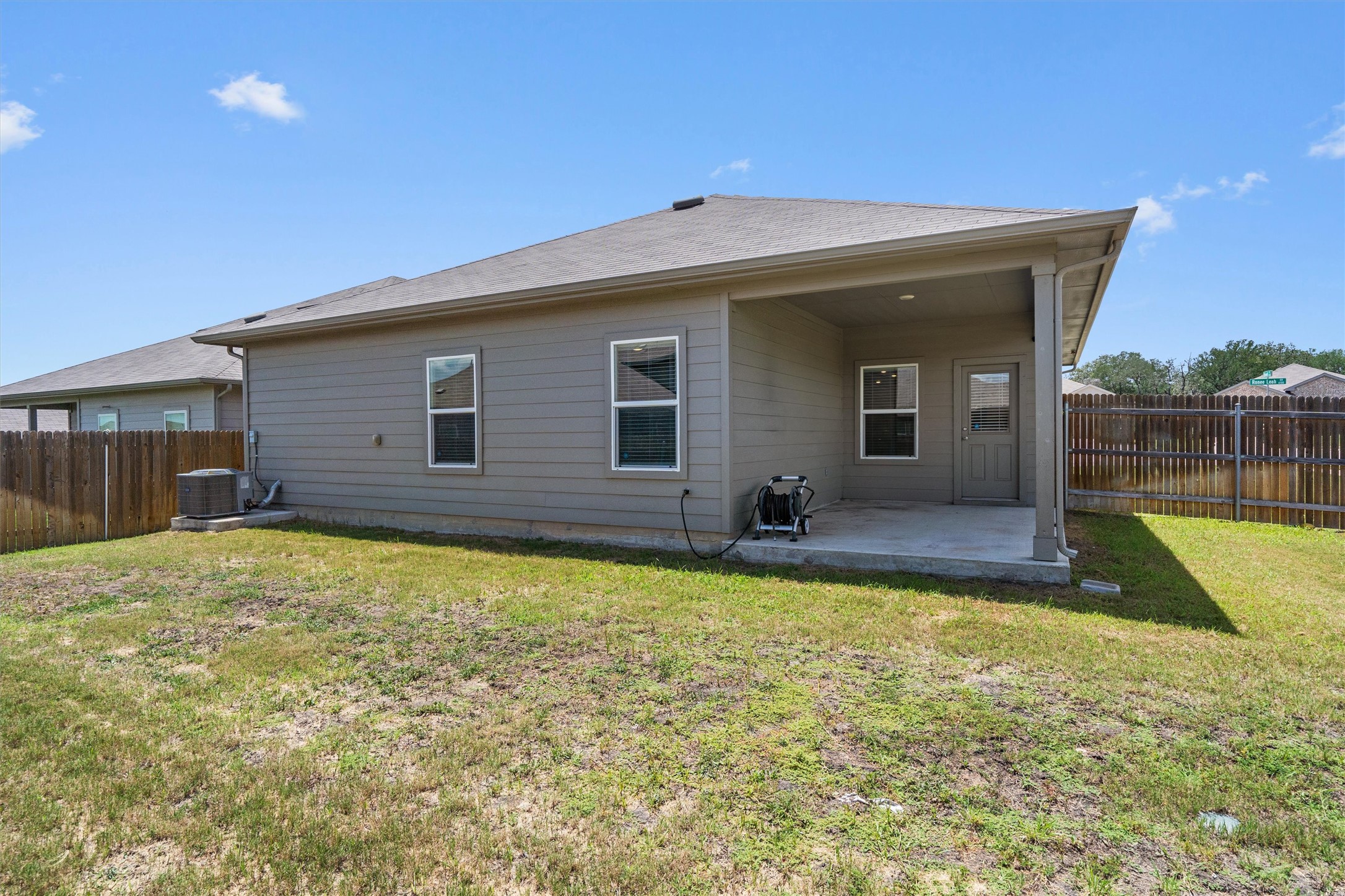 6121 Ronee Leah Drive Austin, TX 78724 - Photo 29 of 30 A well-maintained fenced yard frames this home's convenient covered patio, ideal for outdoor living.