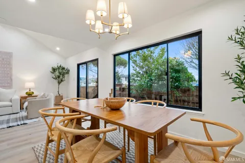 a view of a dining room with furniture and chandelier