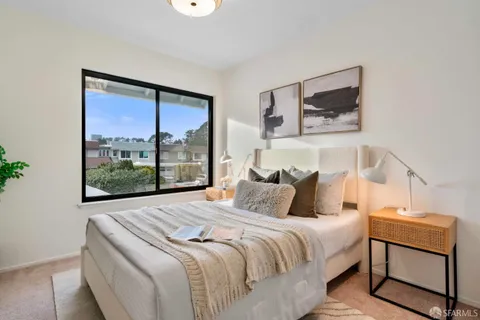 a bedroom with a bed and window