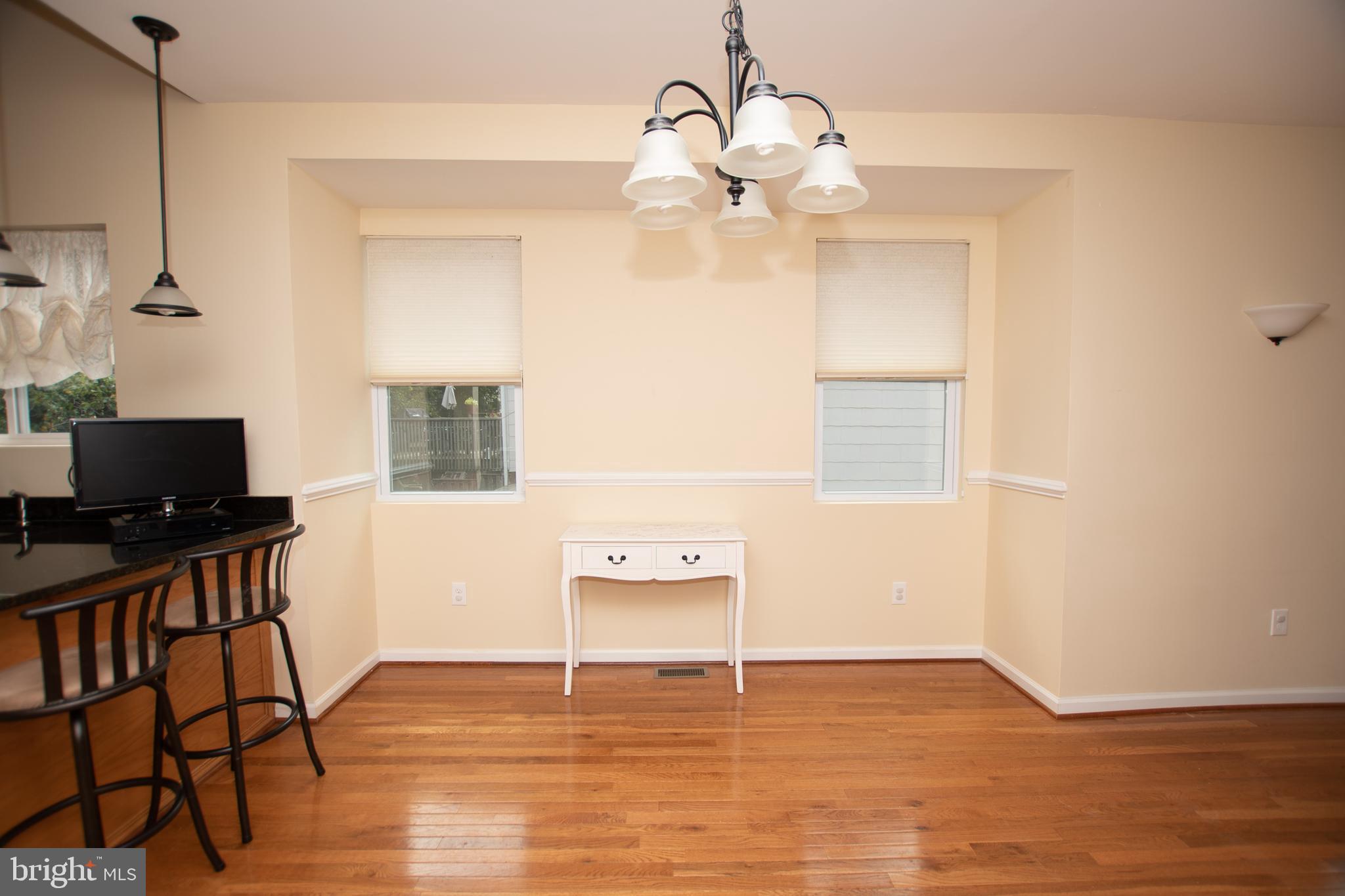 67 Edmondson Ridge Road Baltimore, MD 21228 - Photo 6 of 41 a view of an empty room with a window and wooden floor