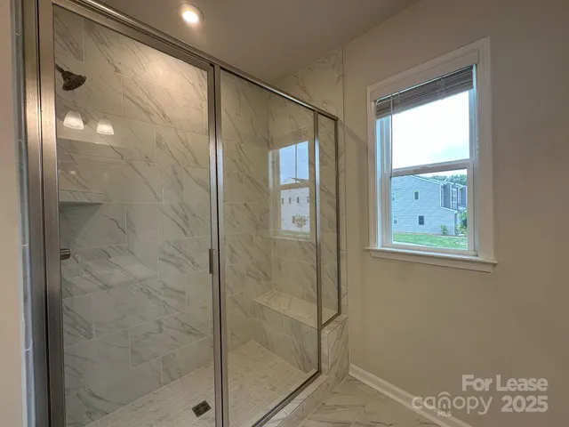 a bathroom with a glass shower door